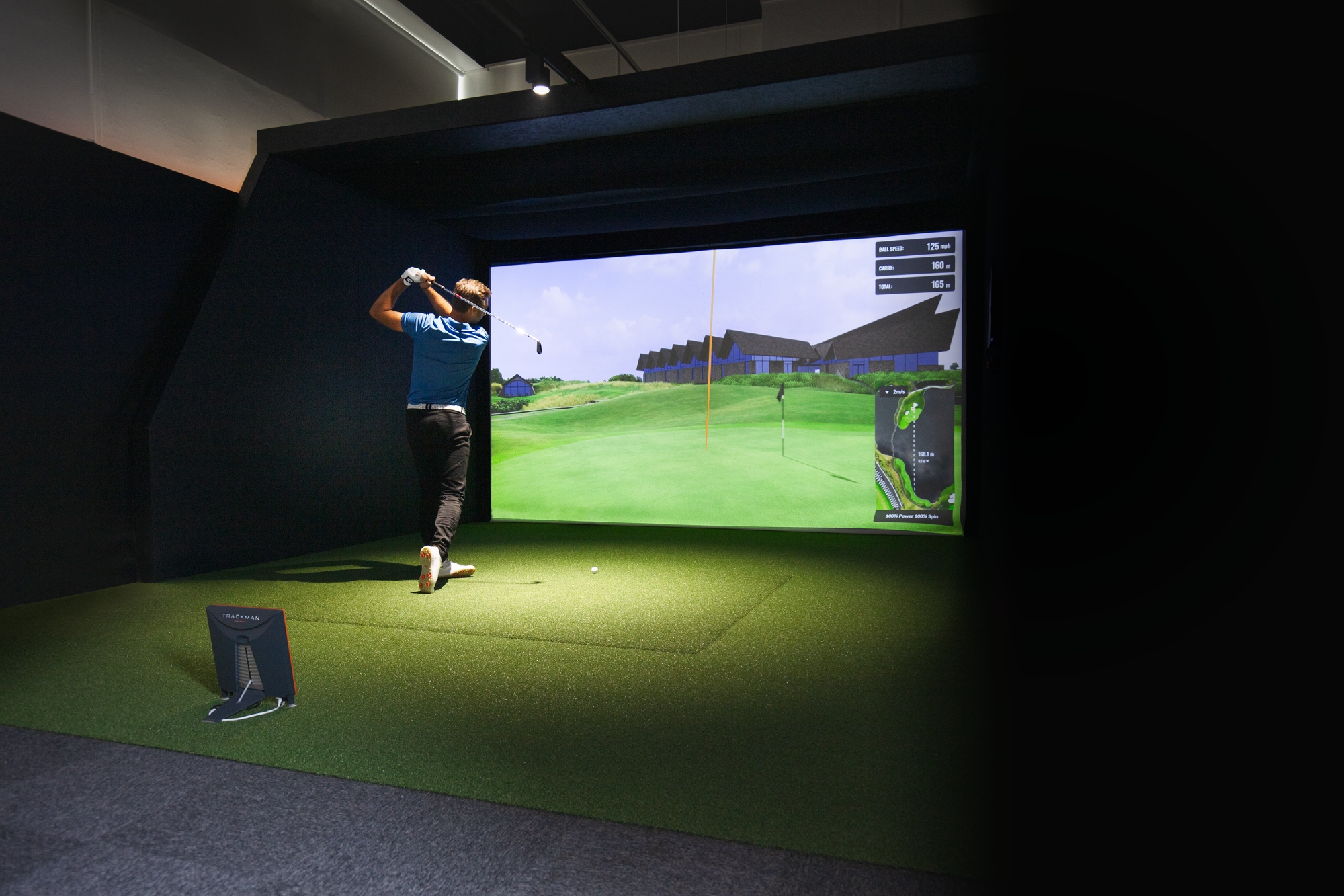 Player swinging in SIM golf simulator