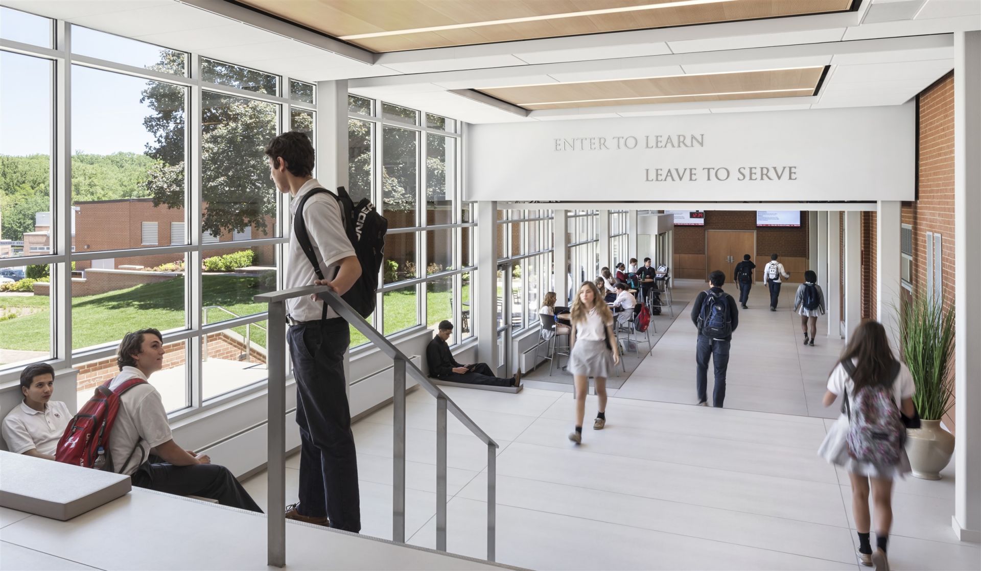 A modern school building with large windows and a spacious hallway for students